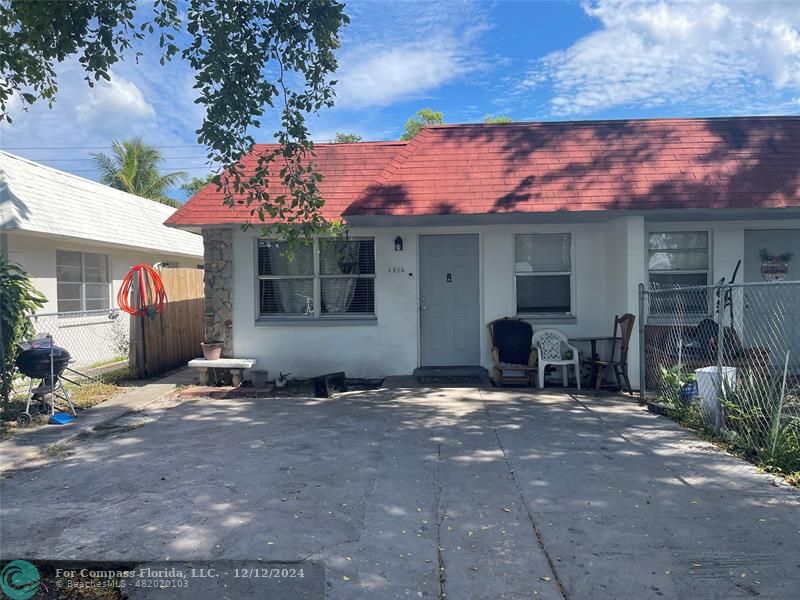 a view of a house with a yard and a garage