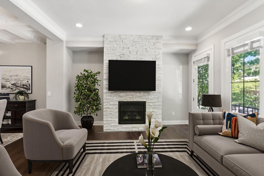 a living room with furniture a flat screen tv and a fireplace