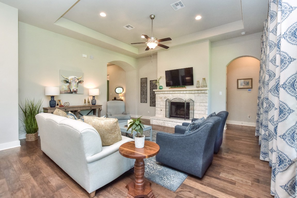 a living room with fireplace furniture and a flat screen tv