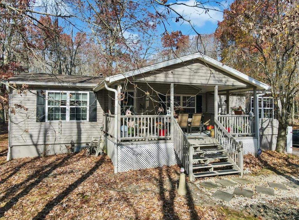 a view of a house with backyard porch and wooden fence