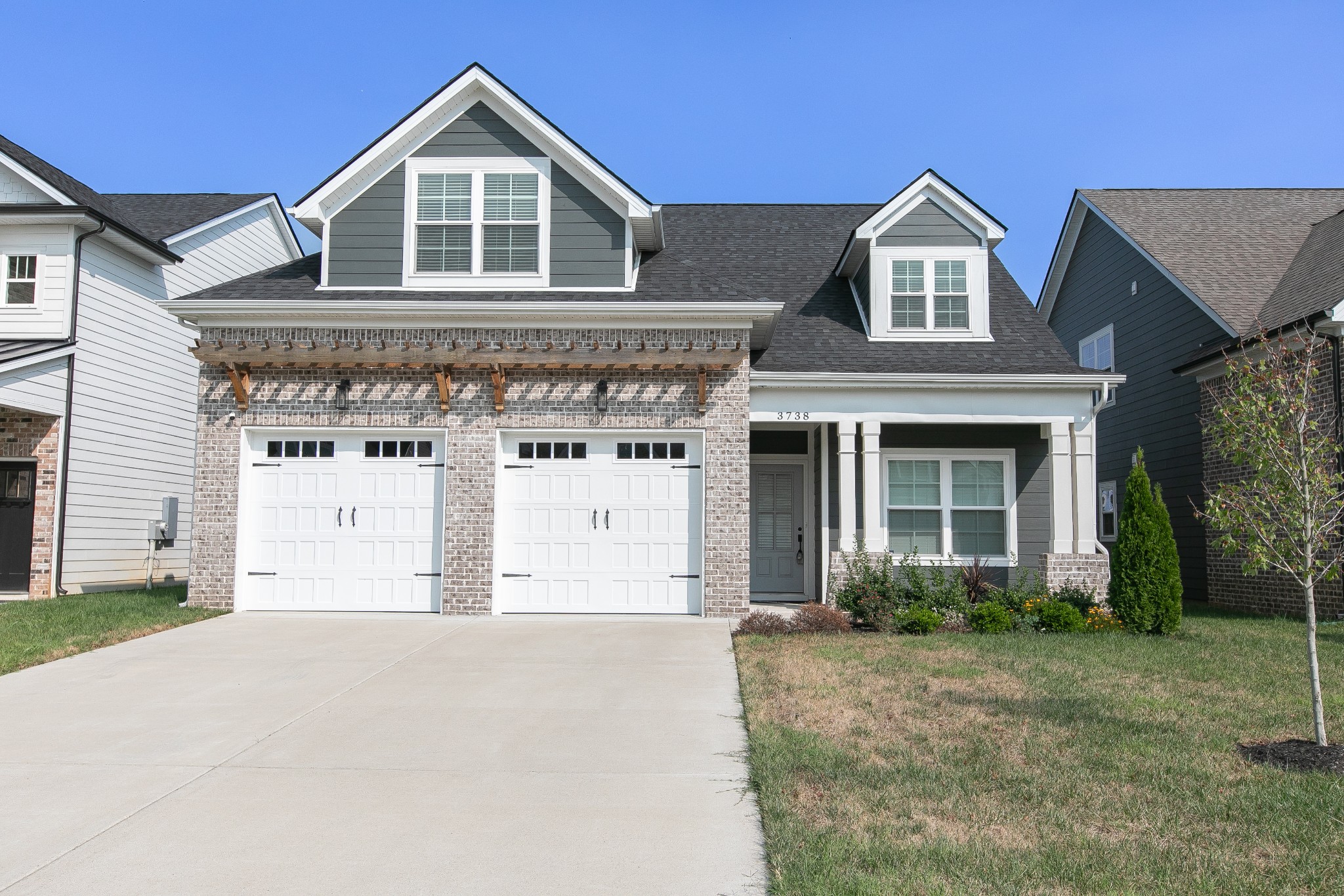 a front view of a house with a yard and garage