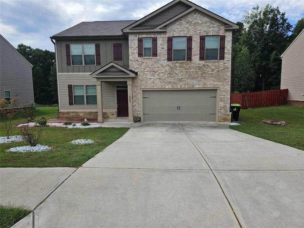 a front view of a house with a yard and trees