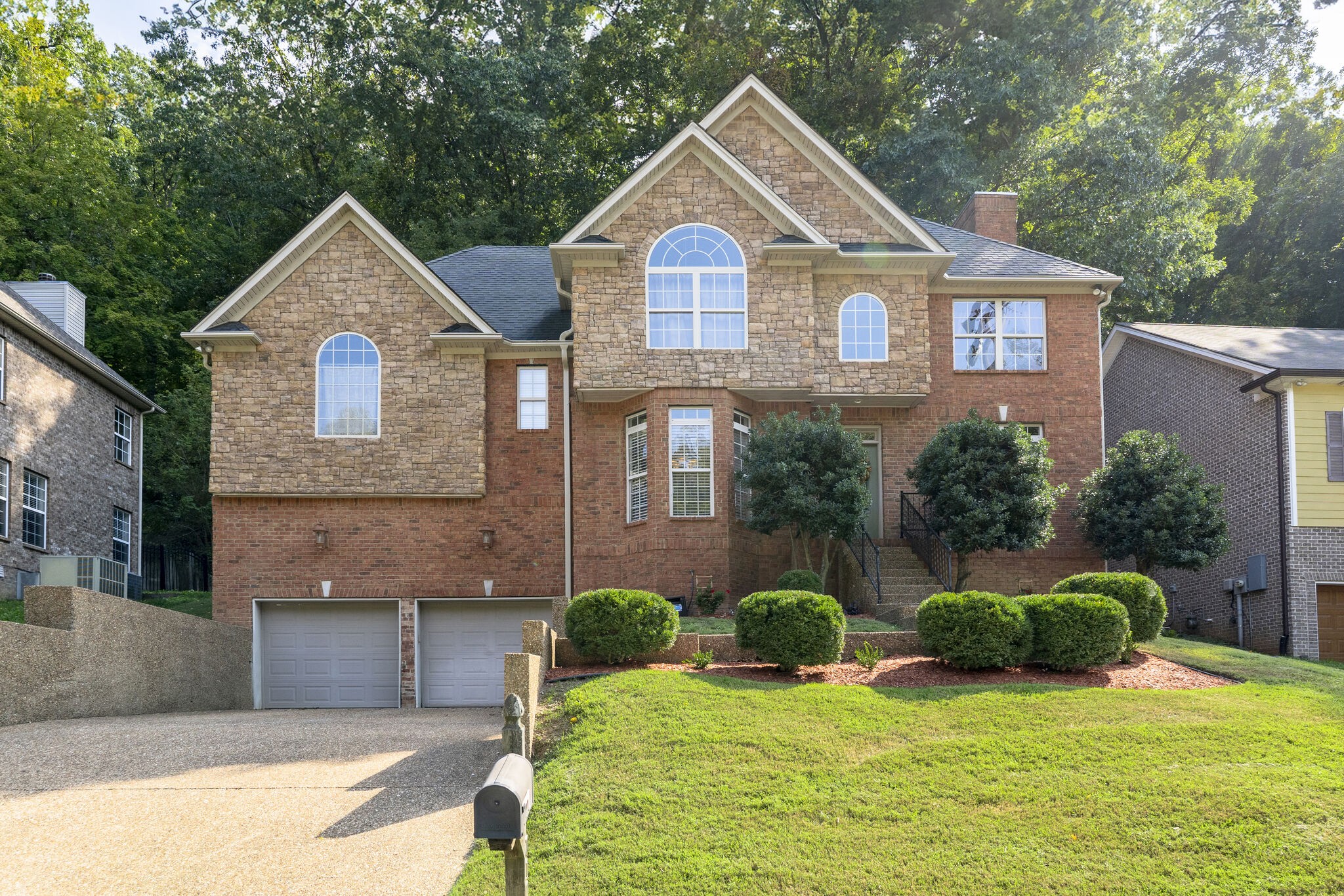 a front view of a house with a yard and garage