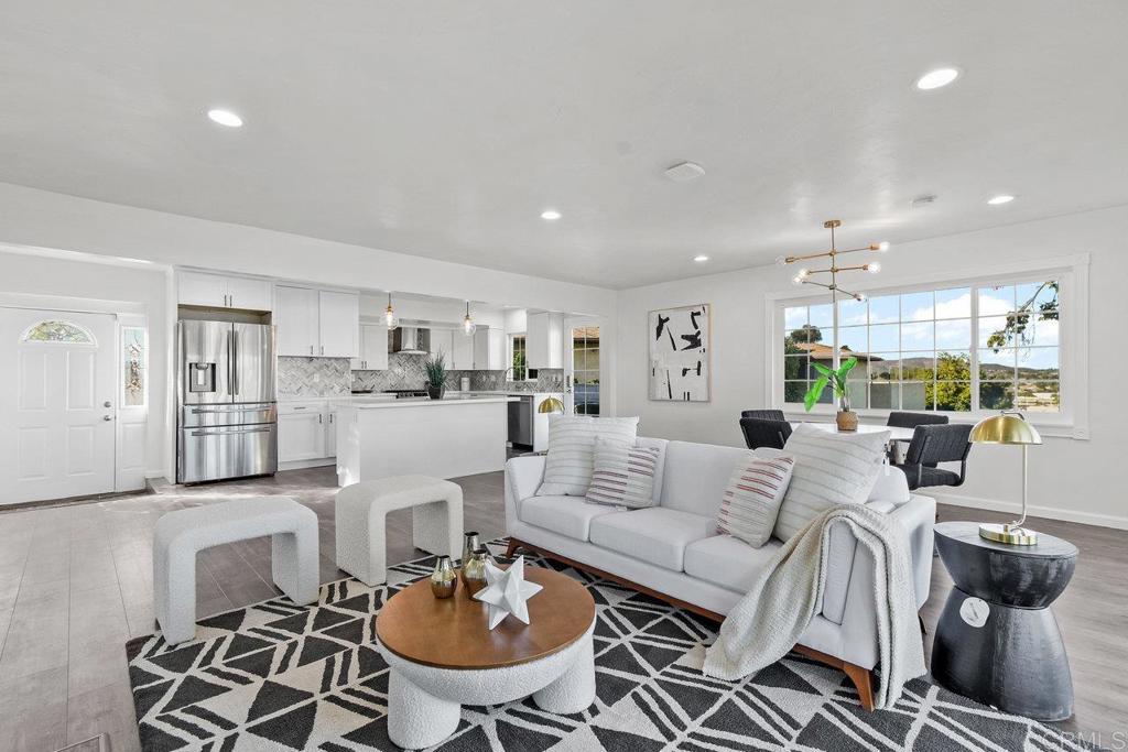 a living room with furniture kitchen and a table