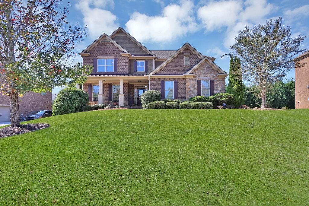 a front view of house with yard and green space