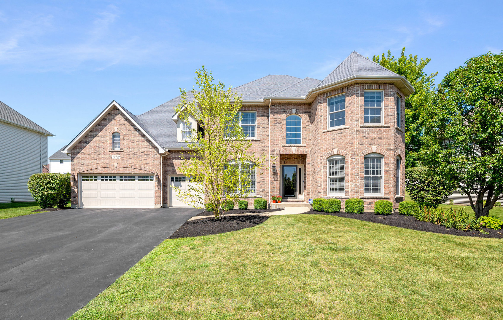 a front view of a house with a yard and garage