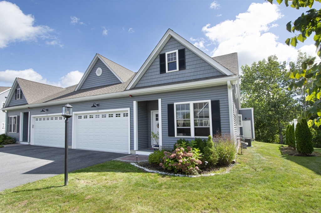 a front view of a house with a yard