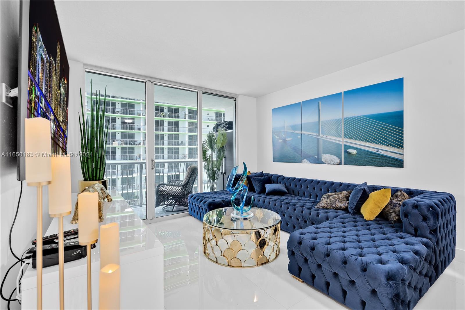 a living room with furniture and a floor to ceiling window