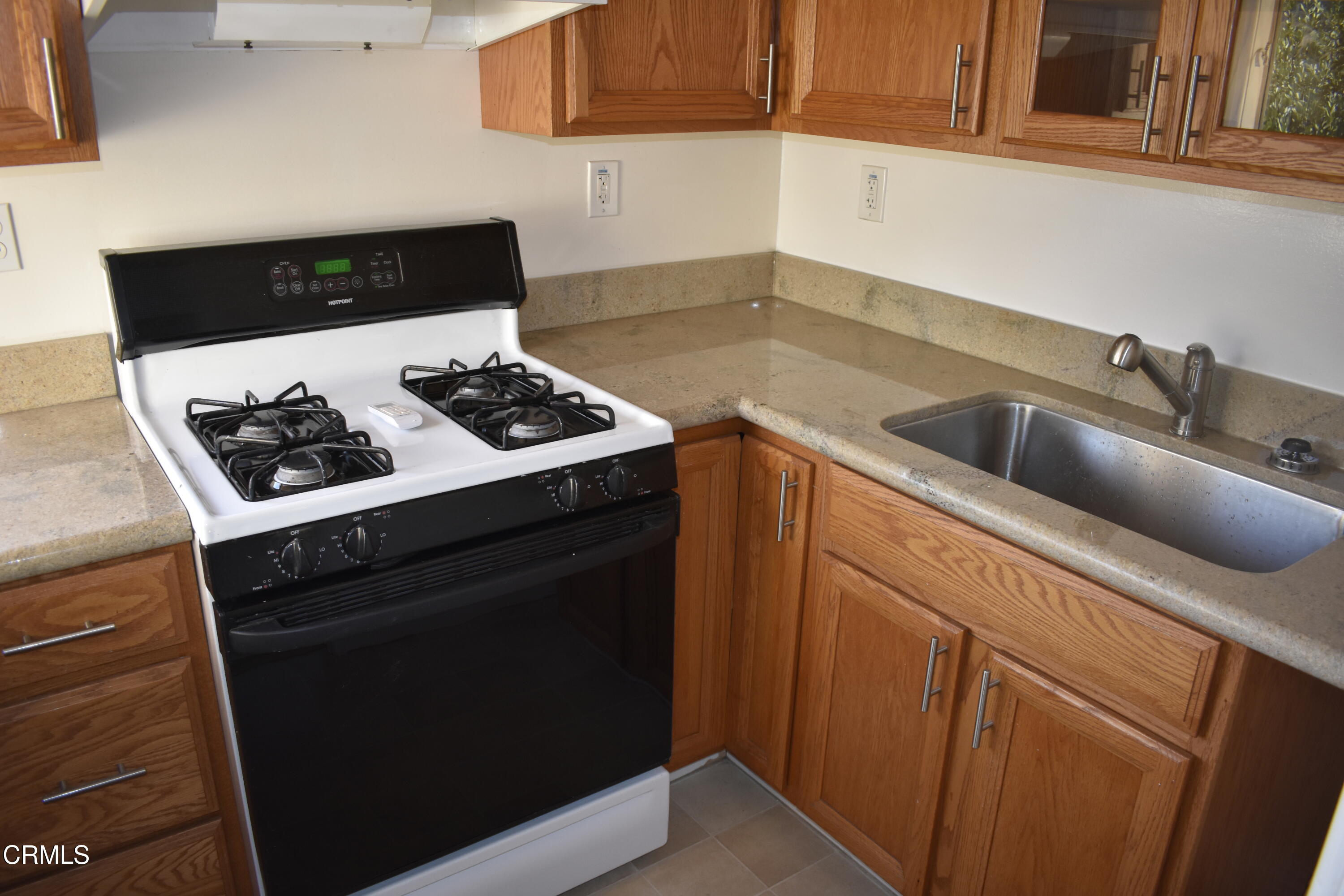 a kitchen with a stove and a sink