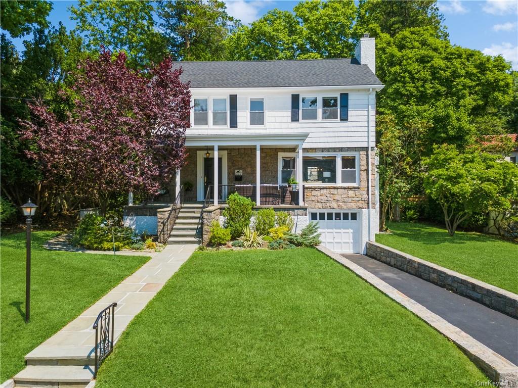 a front view of a house with a yard table and chairs