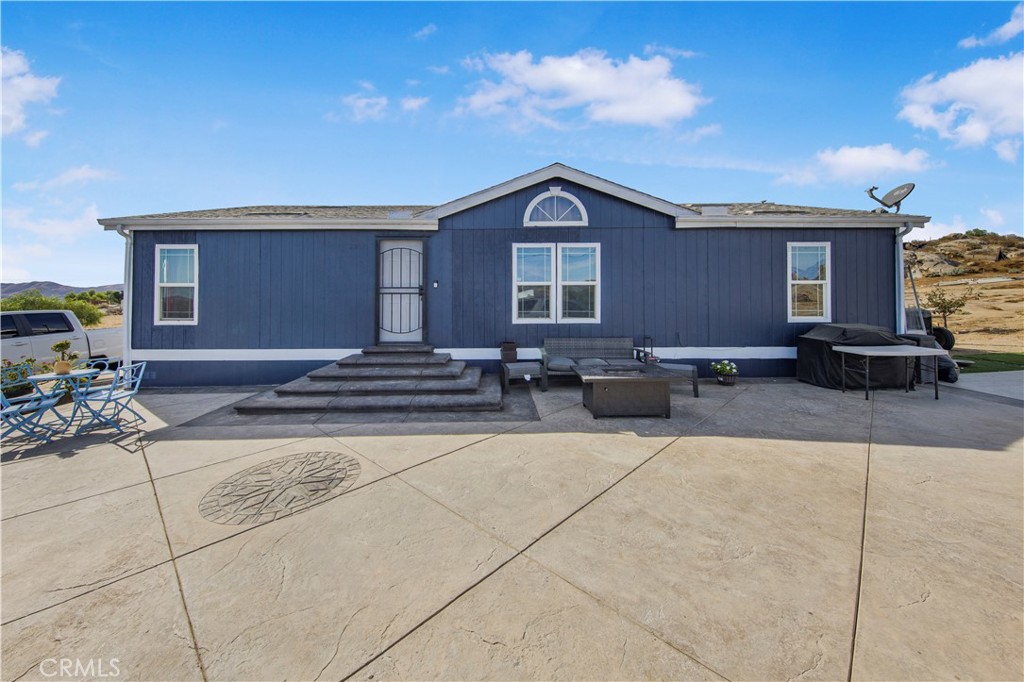 a view of the house with outdoor space and sitting space