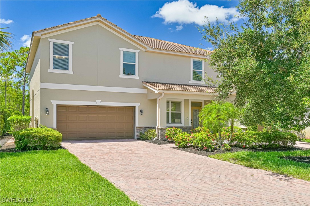 a front view of a house with a yard and garage