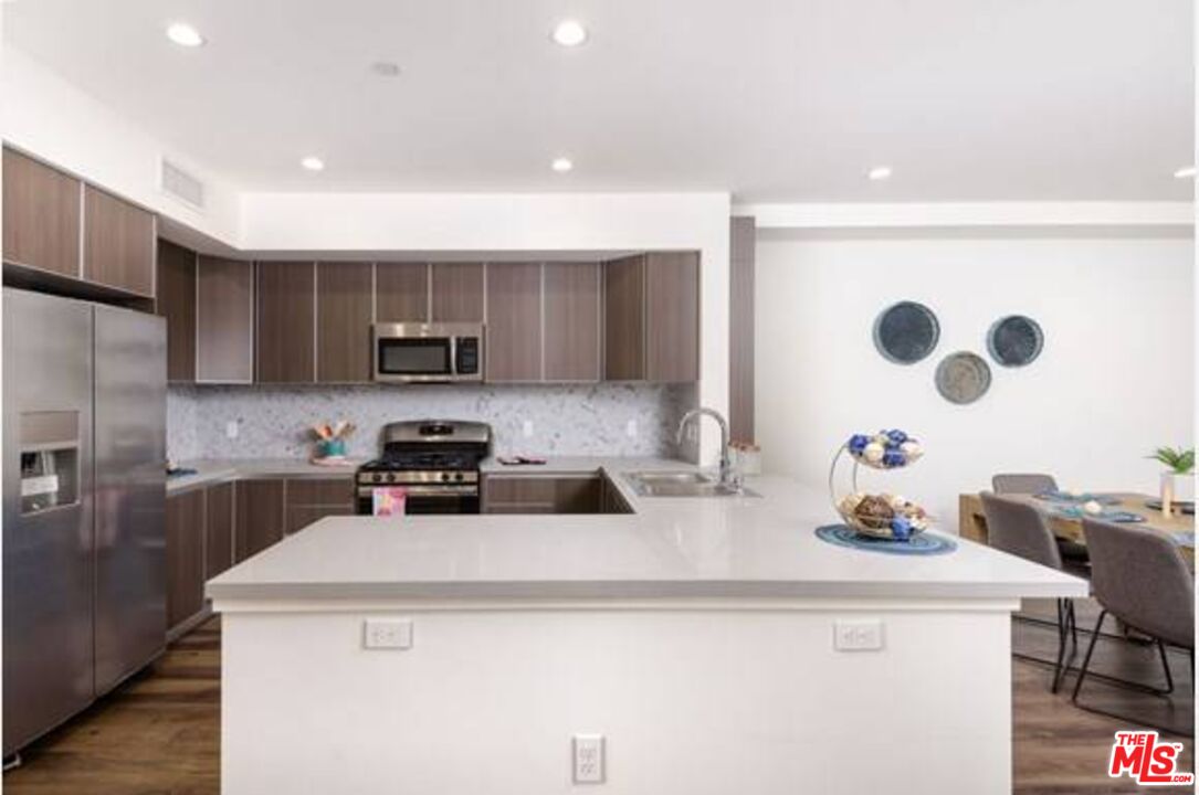 a kitchen with a sink a stove and cabinets