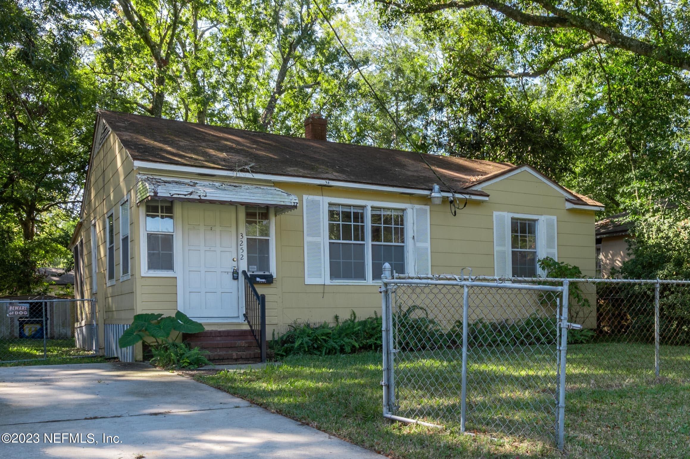 a front view of a house with plants