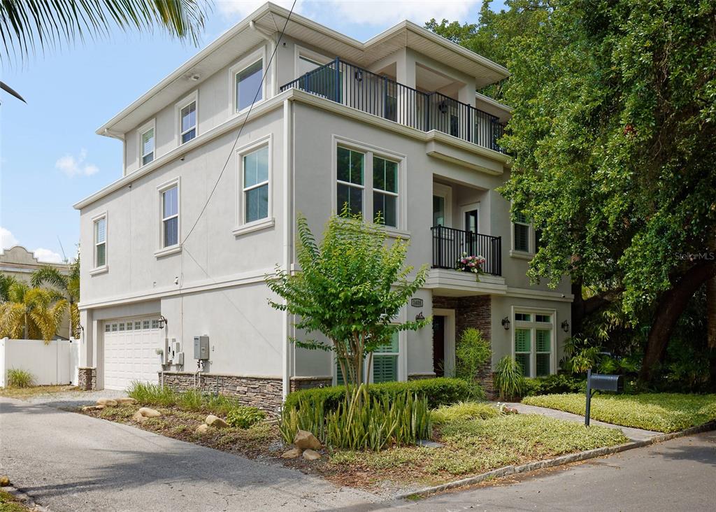 FRONT AND LEFT SIDE OF HOME SHOWING THE PRIMARY BEDROOM ON THE 3RD FLOOR AS WELL AS THE PARTY/VIEWING DECK