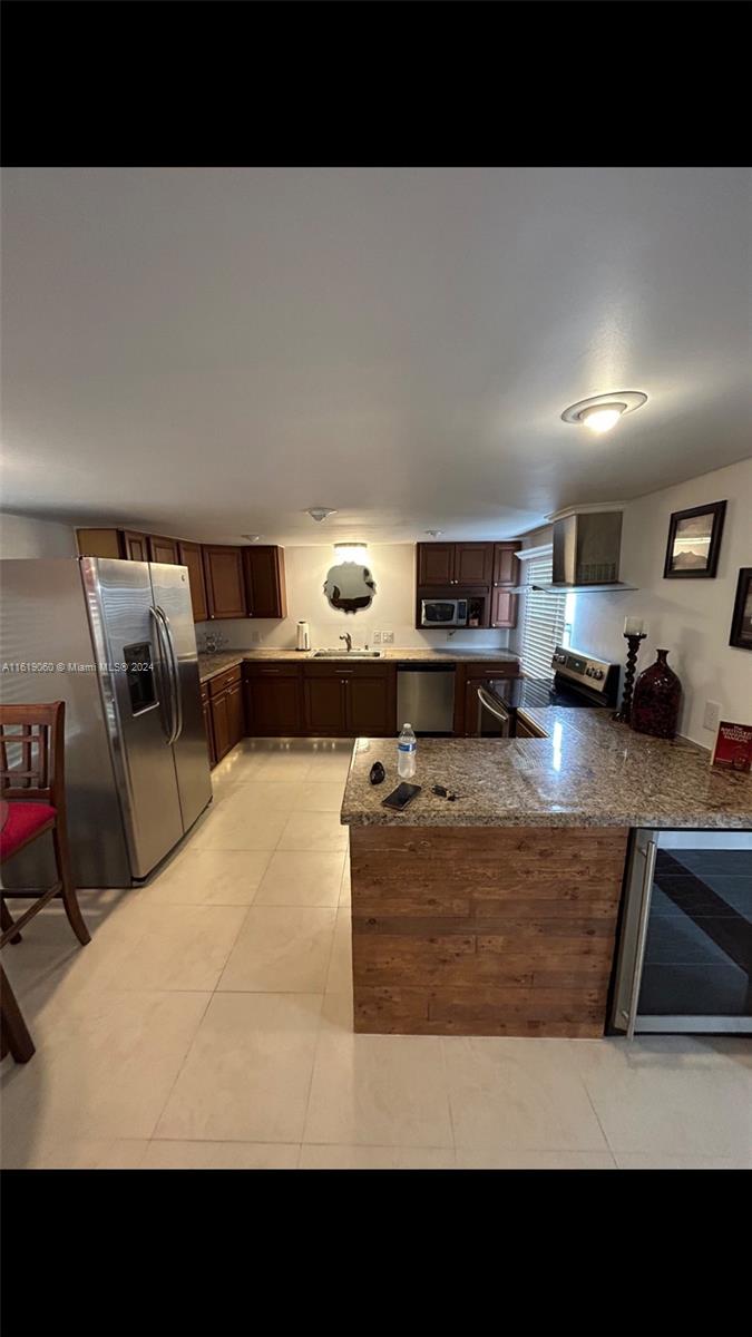 a living room with furniture and a kitchen view