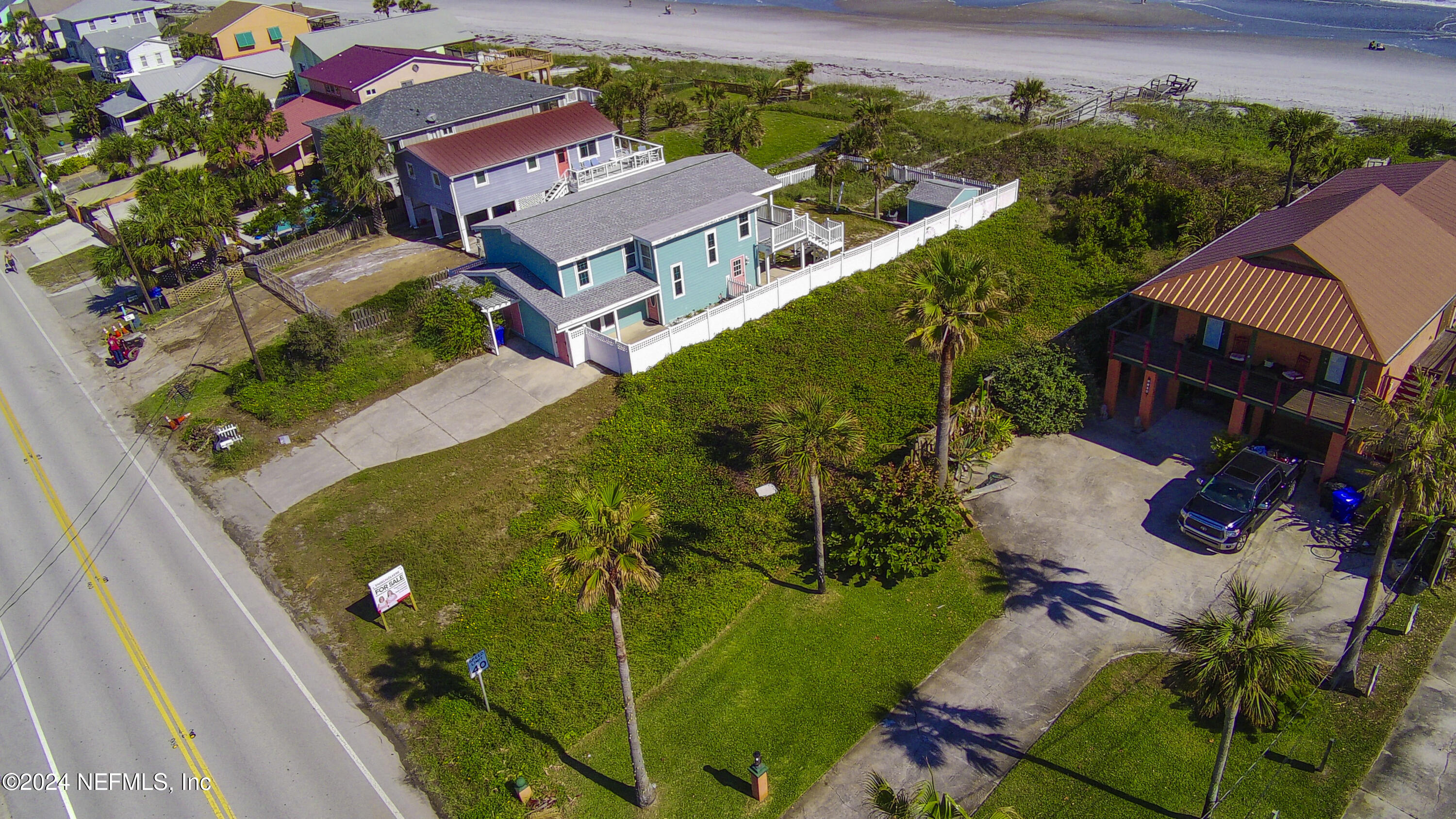 an aerial view of a house with a garden and trees