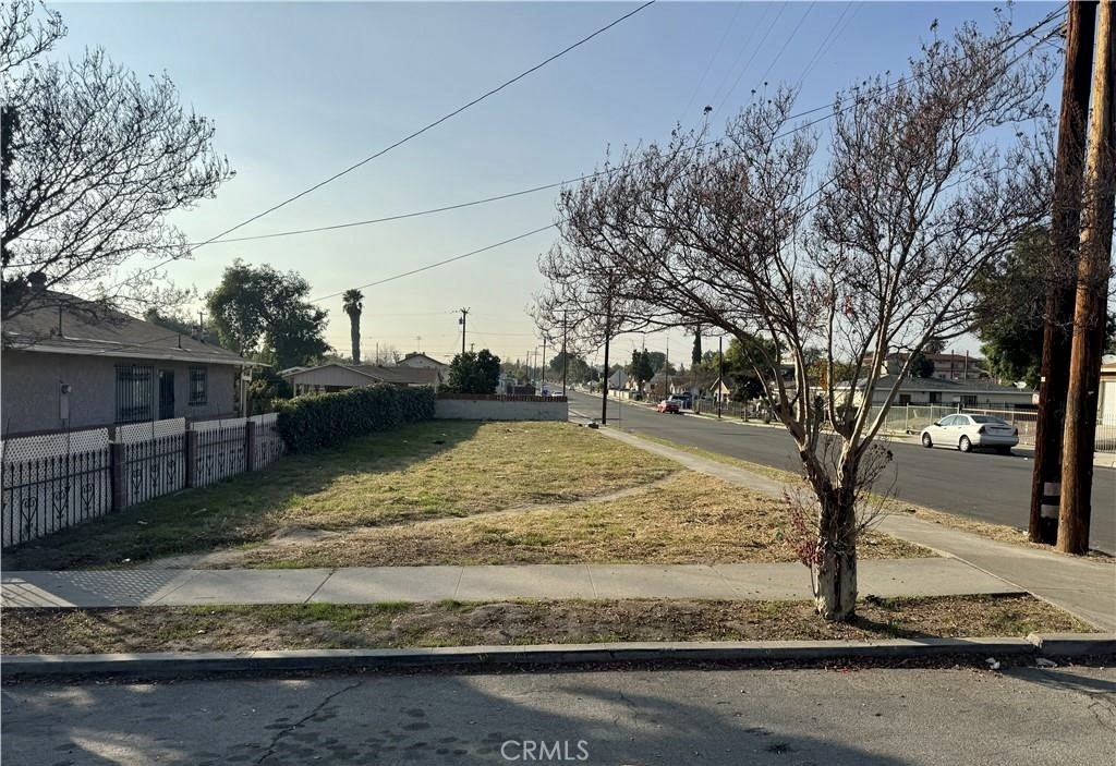 a view of a yard with wooden fence