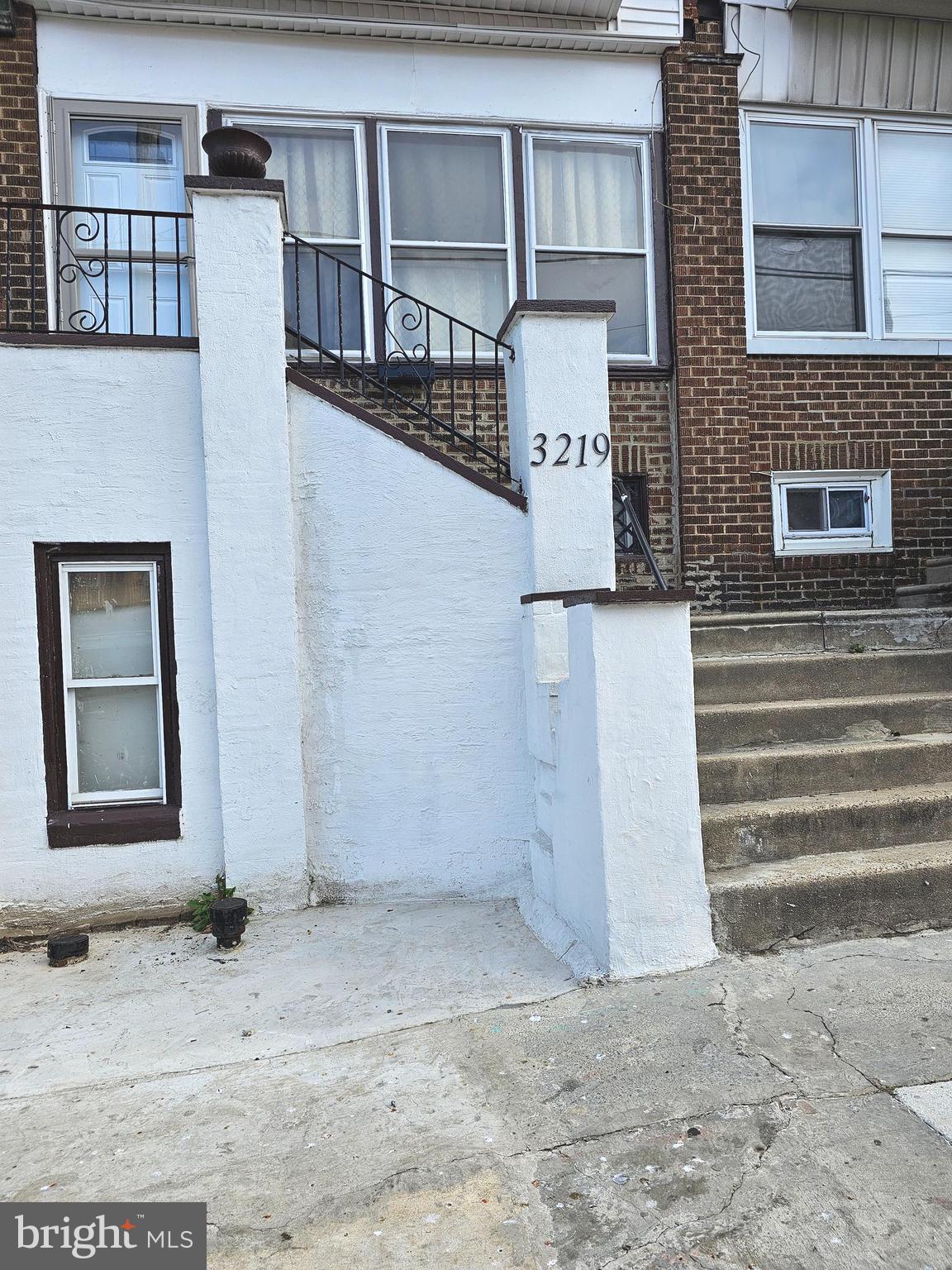 a front view of a house with stairs