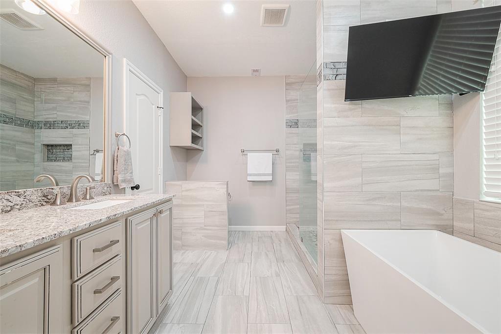 a spacious bathroom with a granite countertop sink a toilet and bathtub