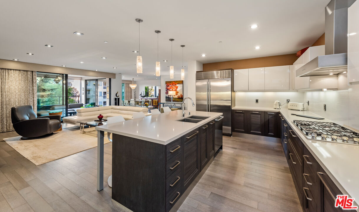 a kitchen with counter top space a sink appliances and cabinets