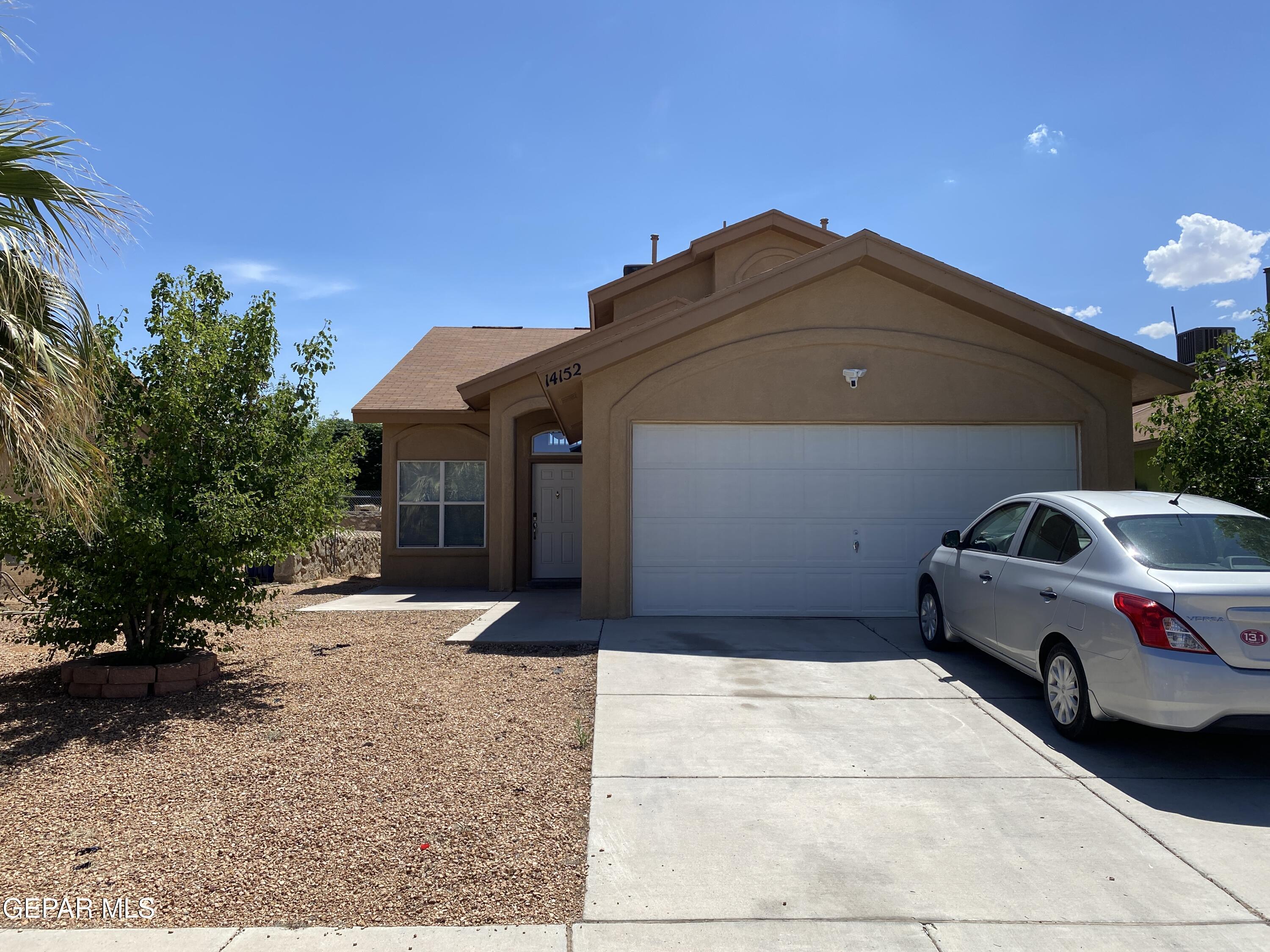 a front view of a house with parking space