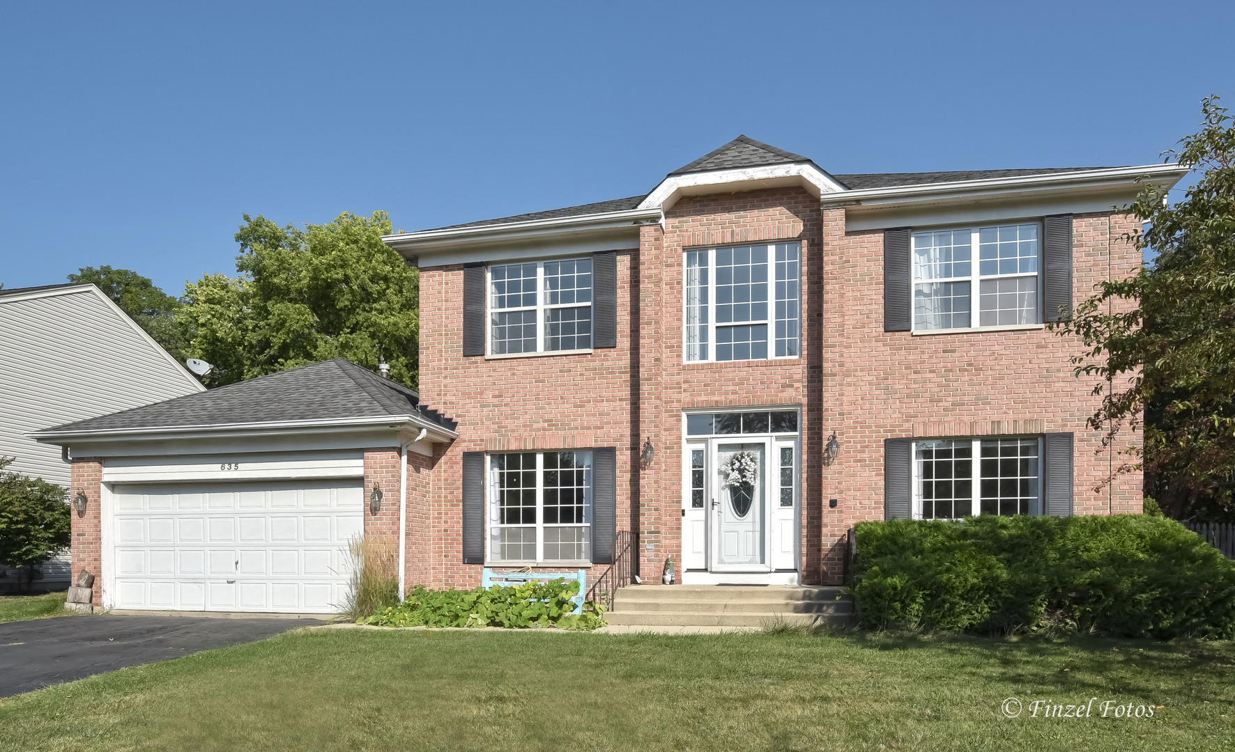 front view of a house with a yard