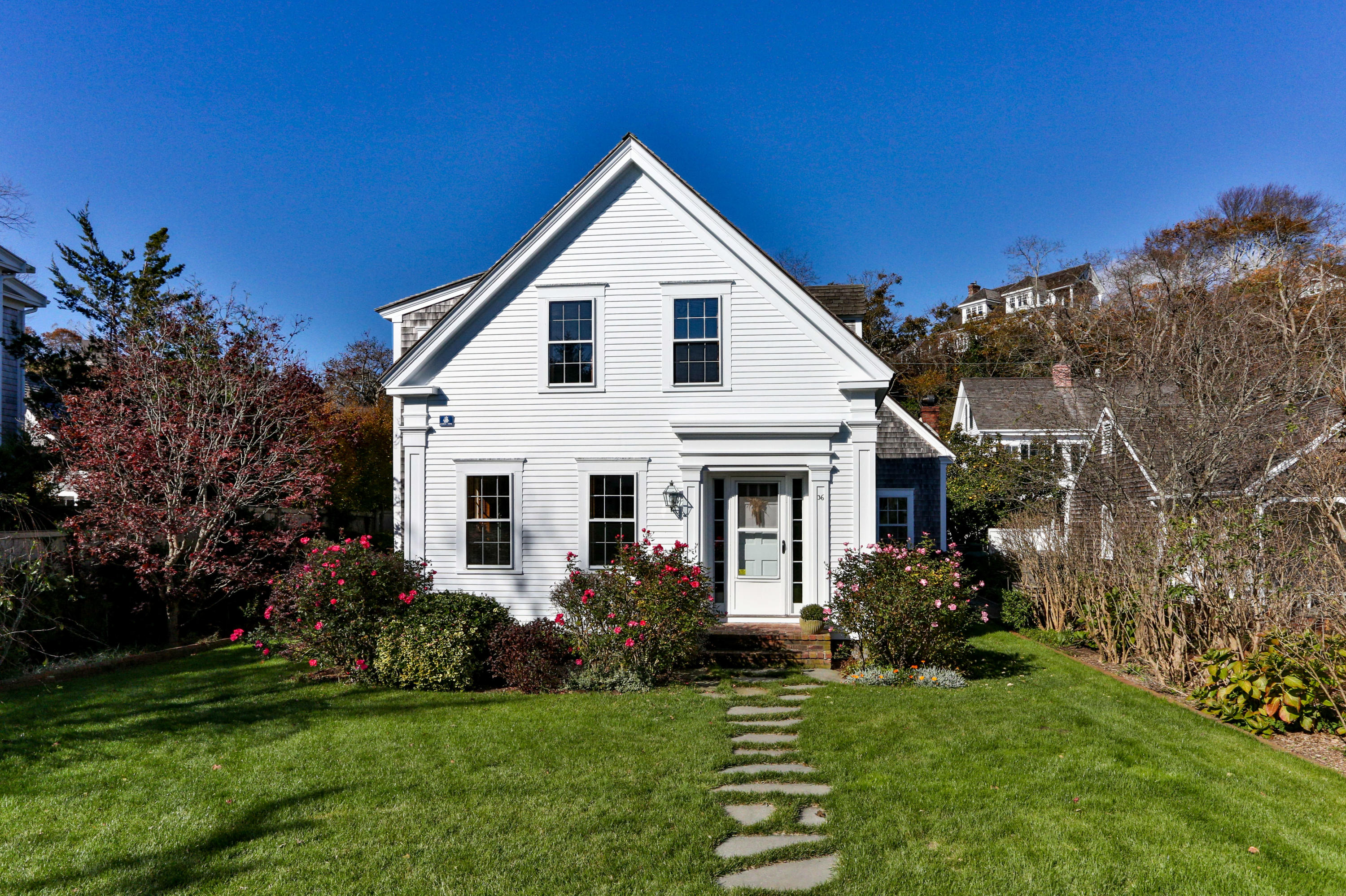 a front view of a house with a garden