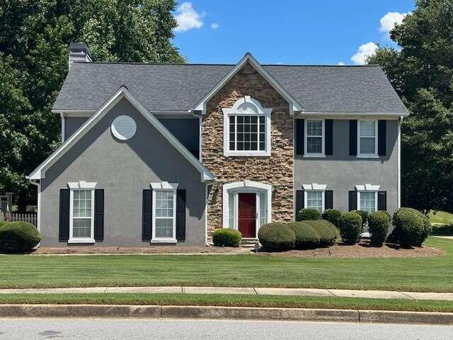 a front view of a house with a yard