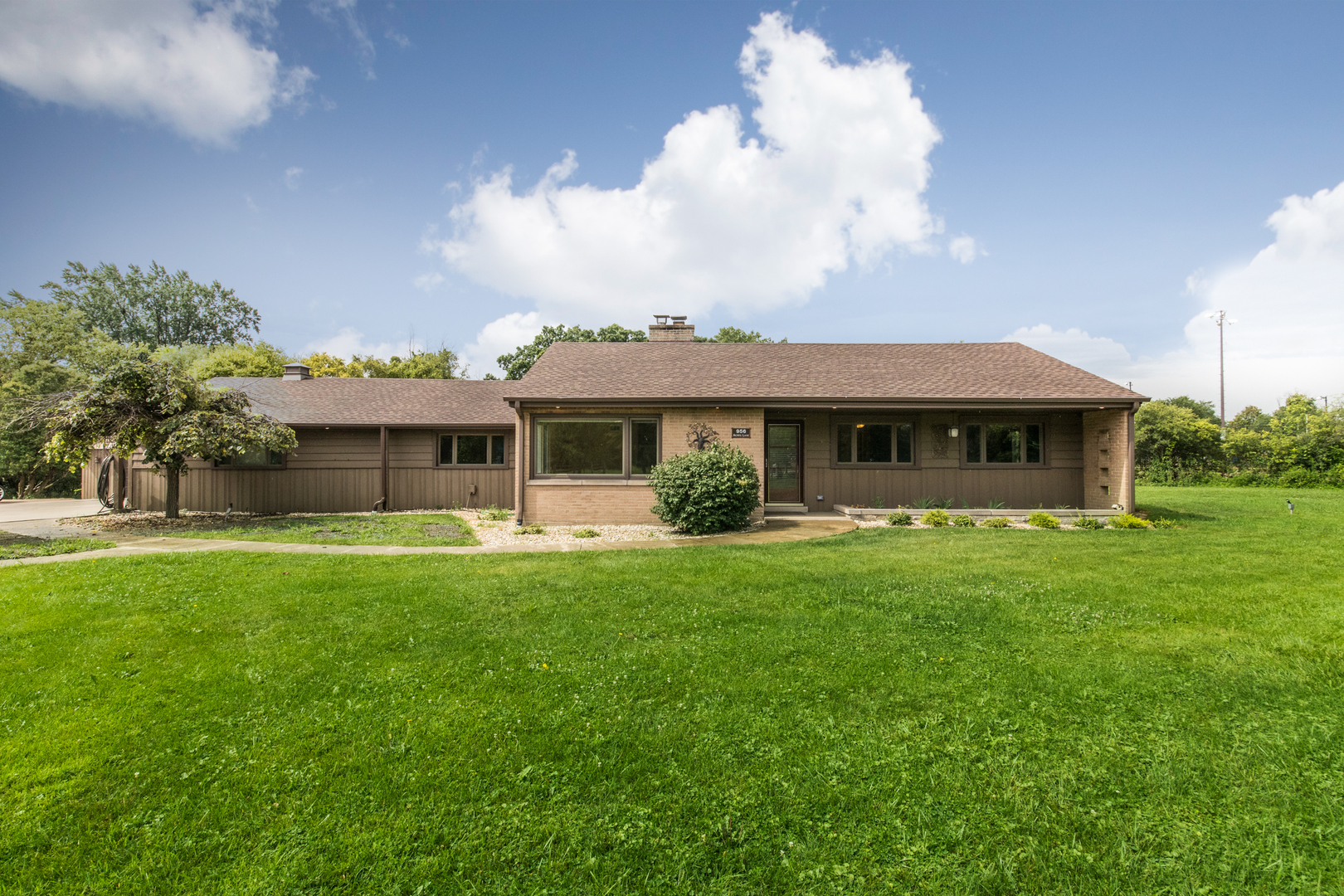 a front view of a house with garden