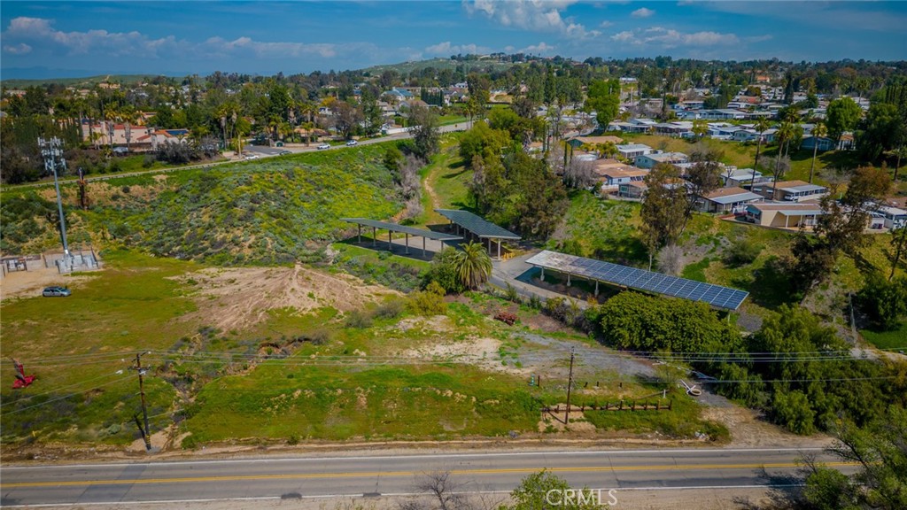 an aerial view of residential houses with outdoor space and trees