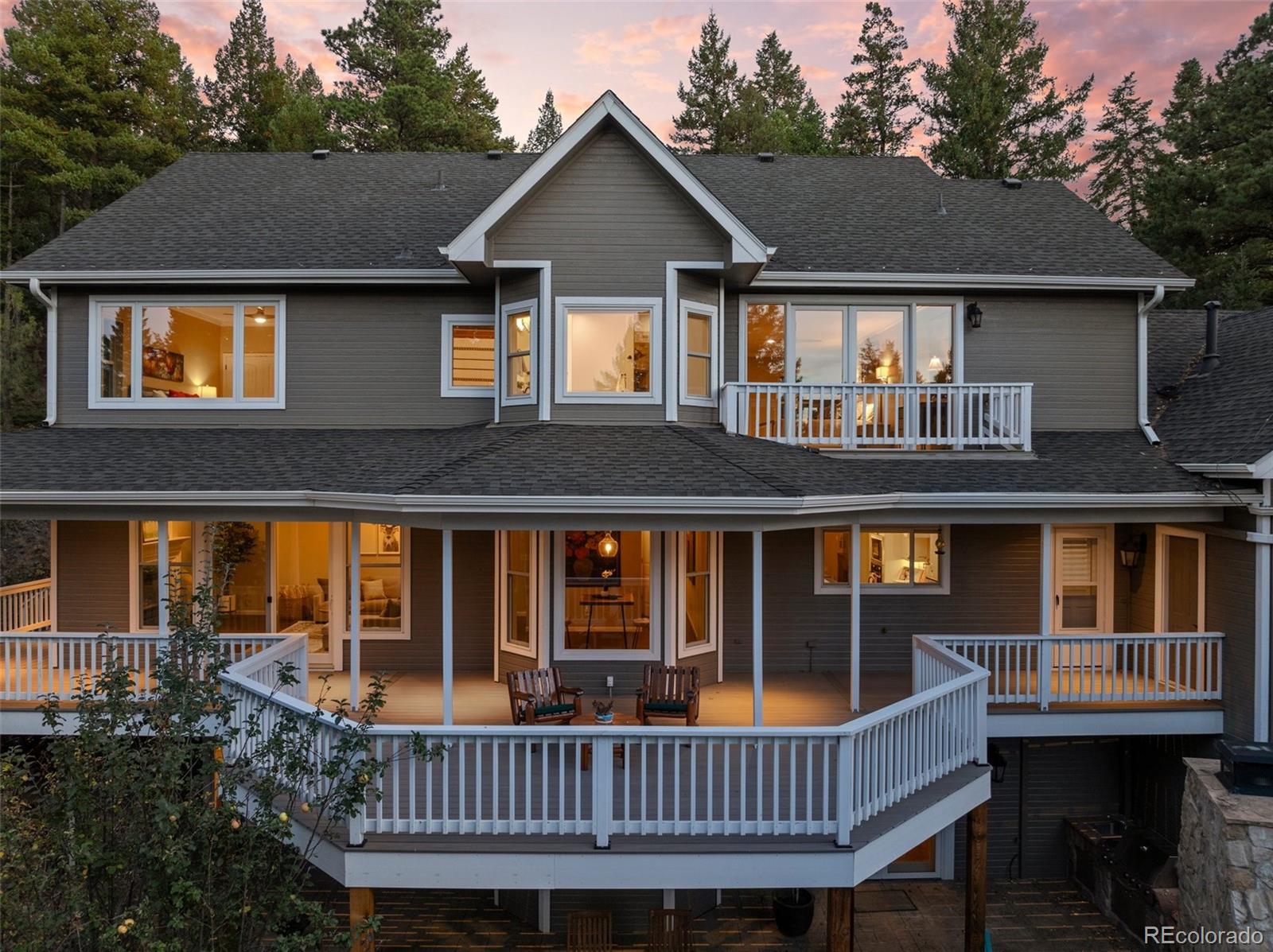 a view of a house with a deck and furniture