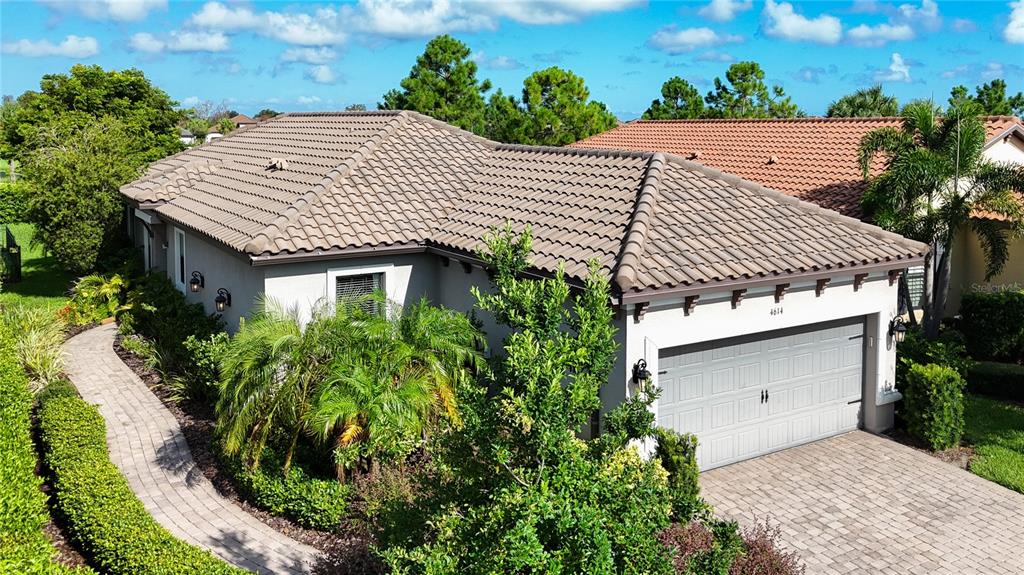 an aerial view of a house with a yard and potted plants