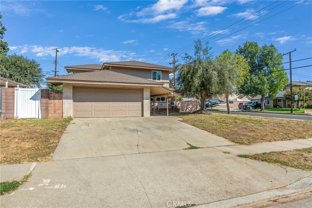 a view of a house with a yard and garage