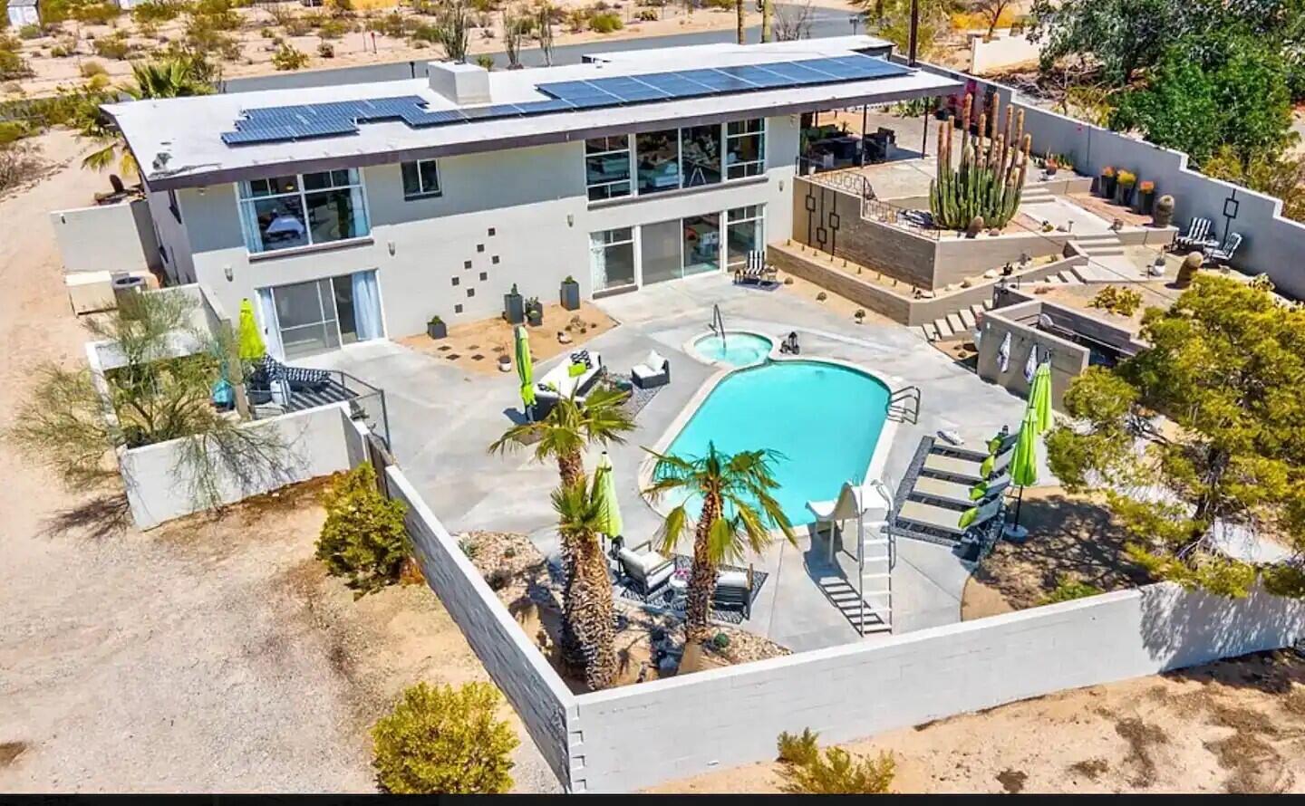 aerial view of a house with swimming pool and sitting area