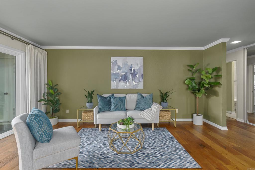 a living room with furniture and a potted plant