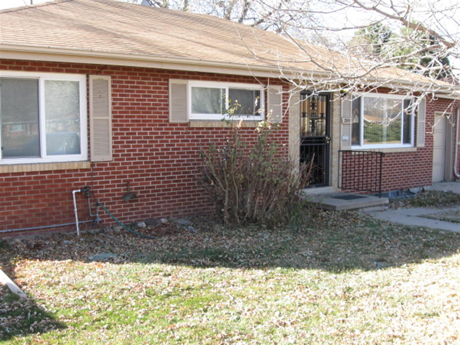 a view of a brick house with a yard