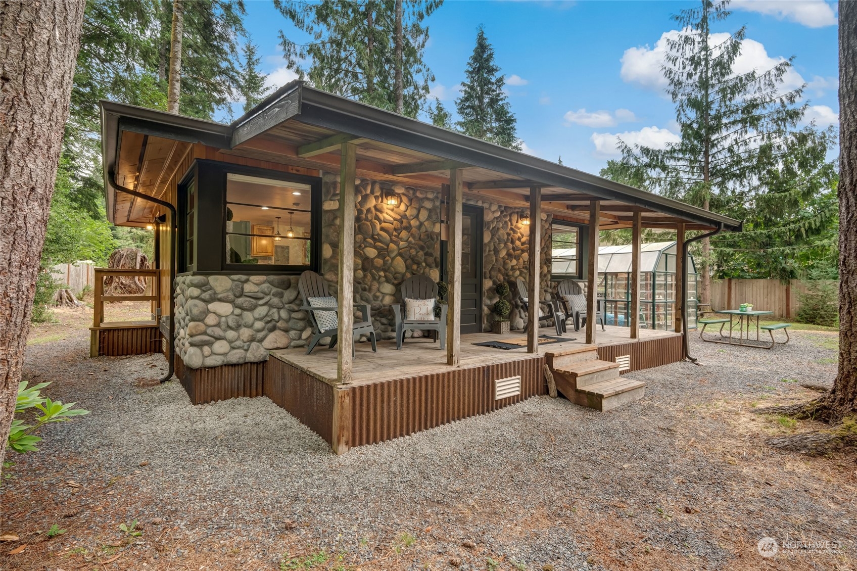 a view of a house with backyard and sitting area