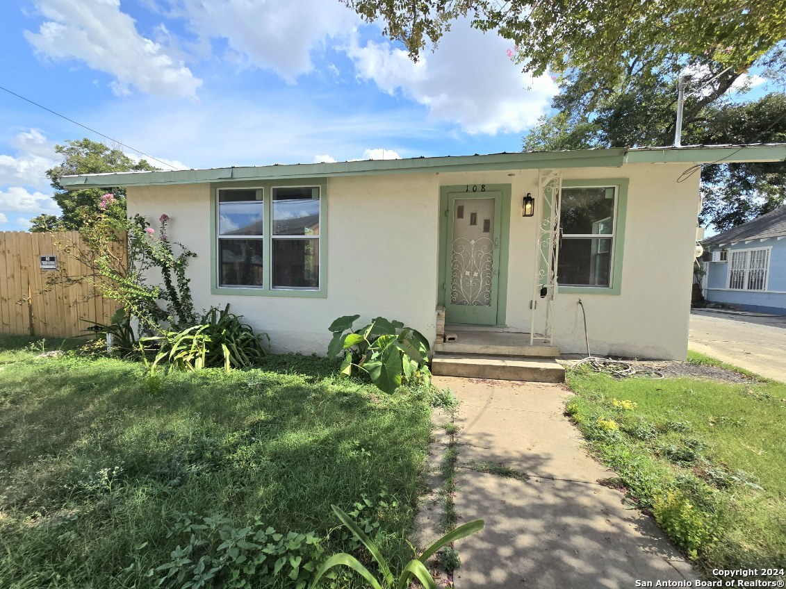 a view of house with backyard