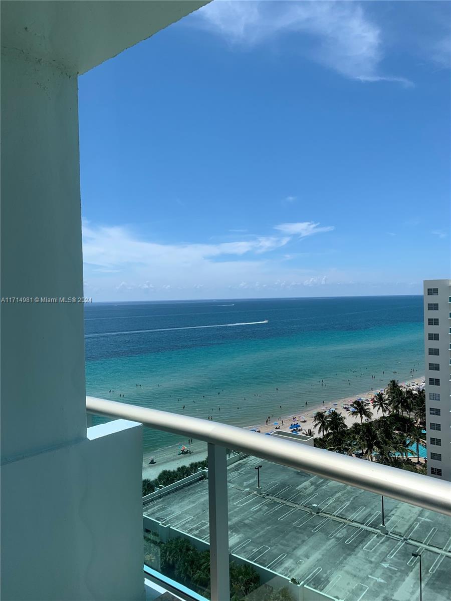 a view of a balcony and a yard