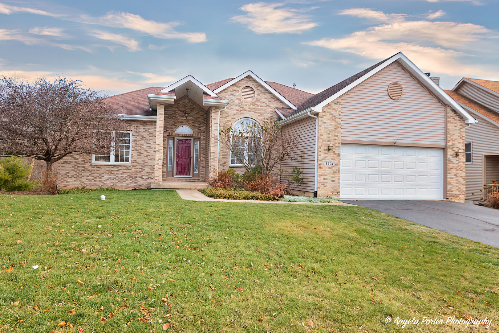 a front view of house with yard and green space