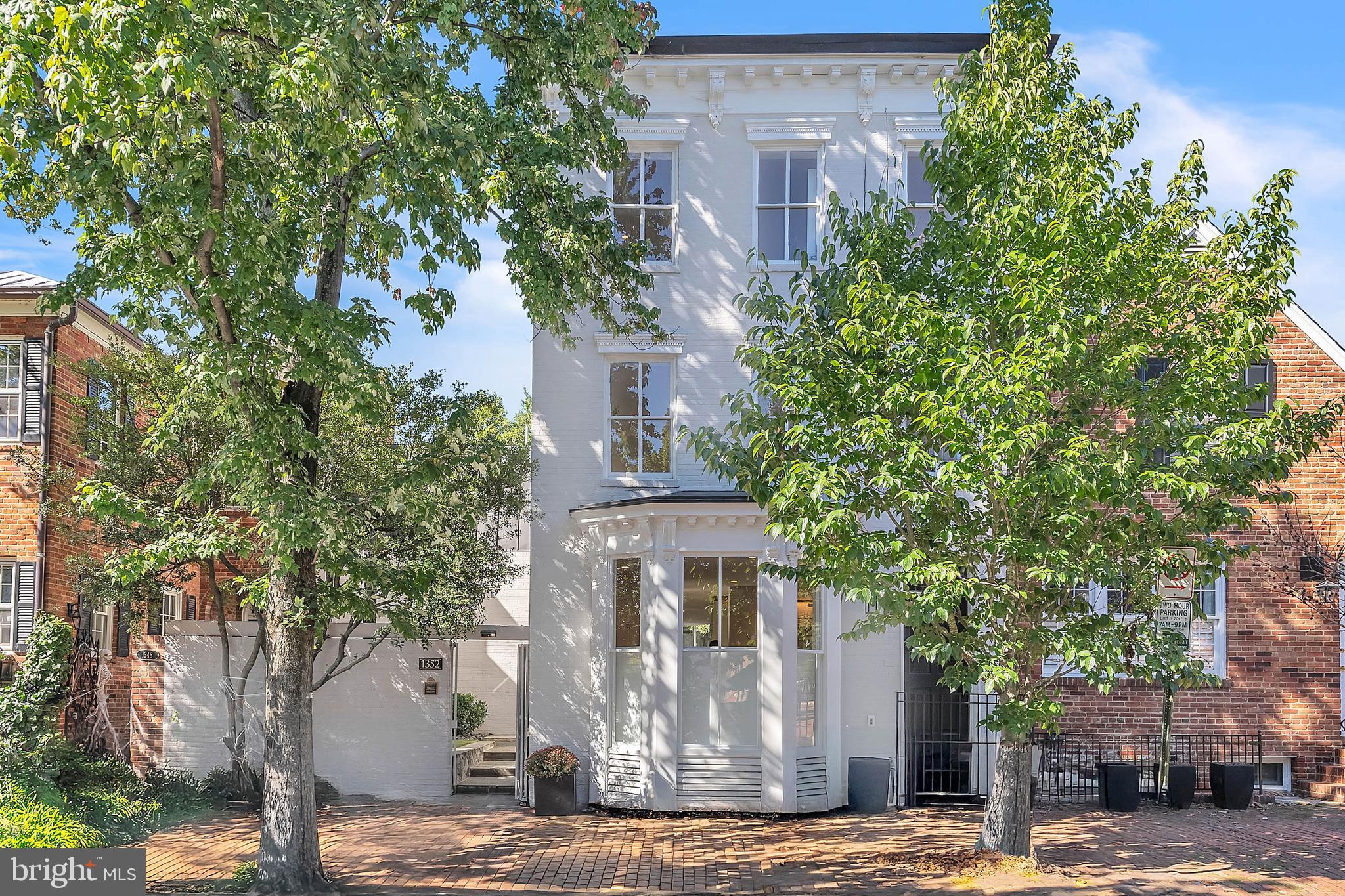 a front view of a building with trees