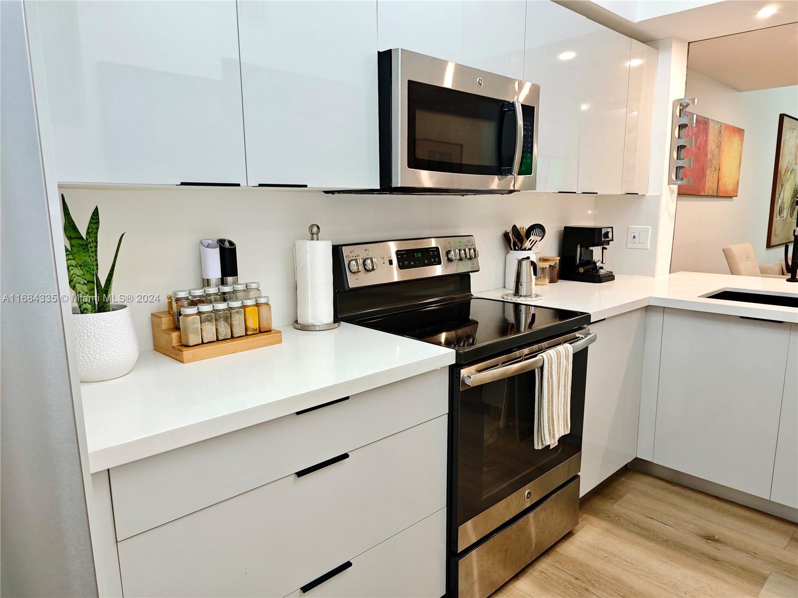 a kitchen with a stove a sink and a microwave