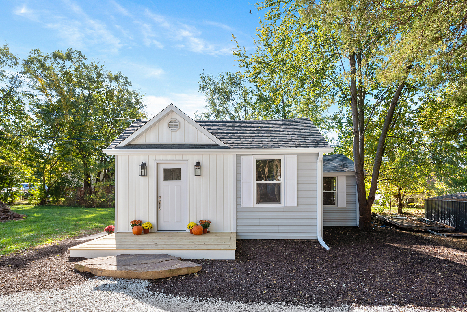 a view of a small house with a yard