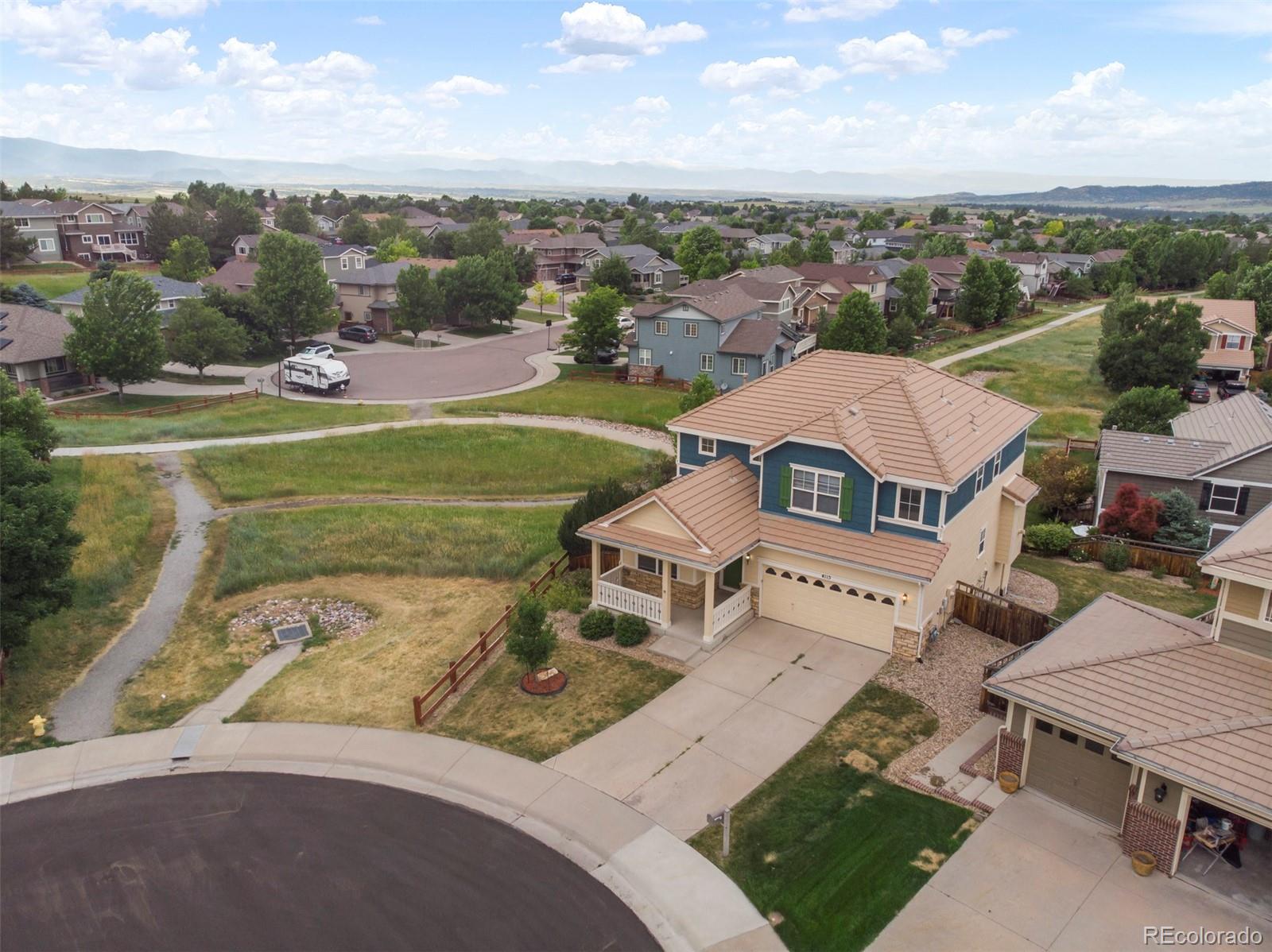 an aerial view of a house with garden space and street view