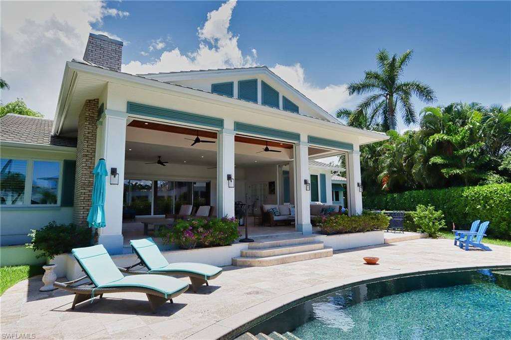 a view of a house with backyard sitting area and garden