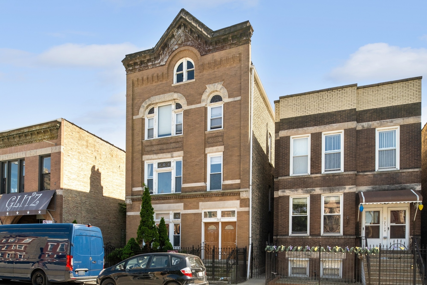 a front view of a residential apartment building with a yard