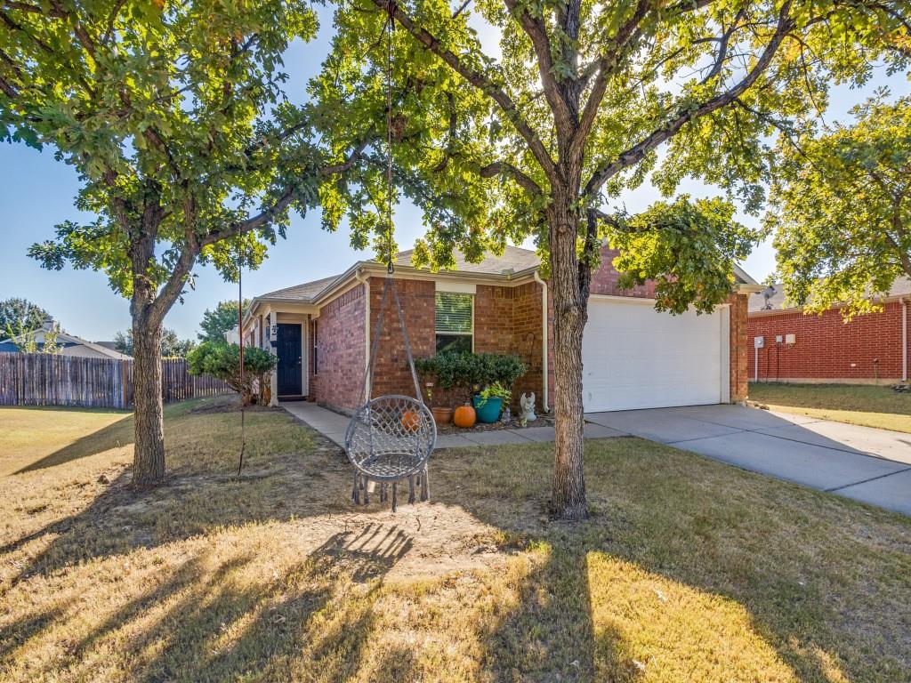 a view of a house with a yard and tree