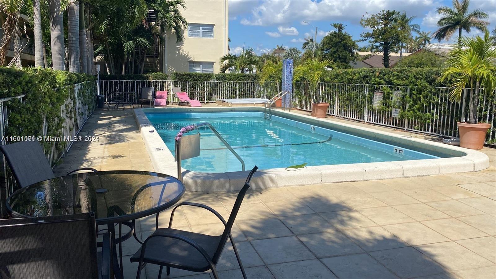 a view of swimming pool with a patio and a yard