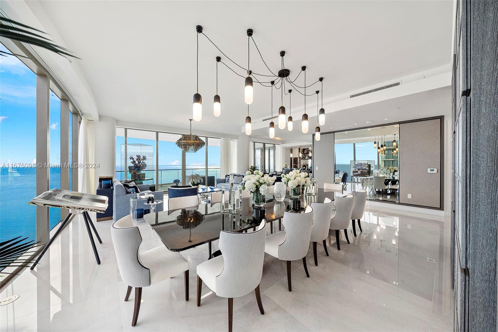 a view of a dining room with furniture and chandelier